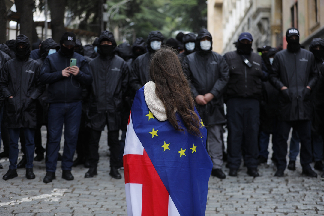 A pro-European Union protester stands outside the security perimeter of the Georgian Parliament.