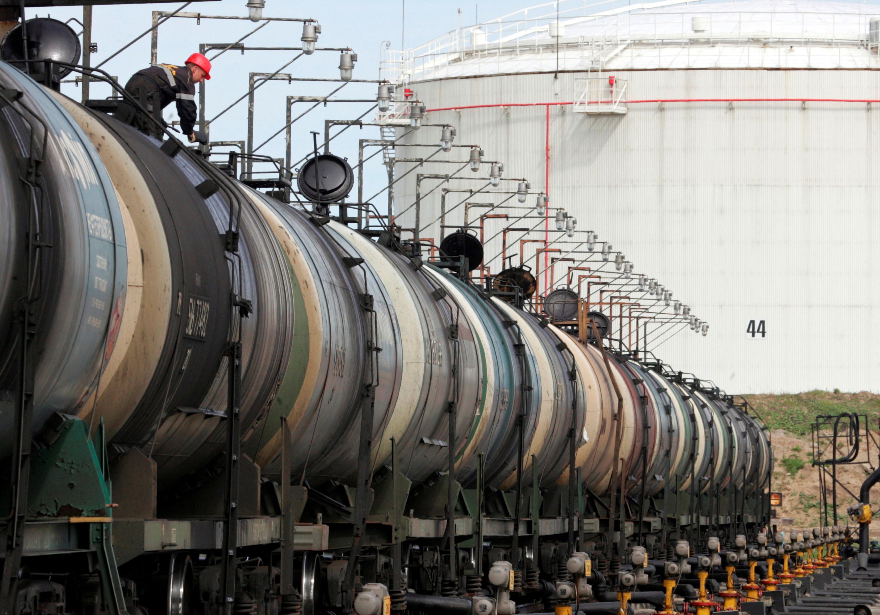A worker controls the freight level of a tanker wagon at the Rosneft oil terminal in Arkhangelsk, Russia. Sergei Karpukhin/Reuters