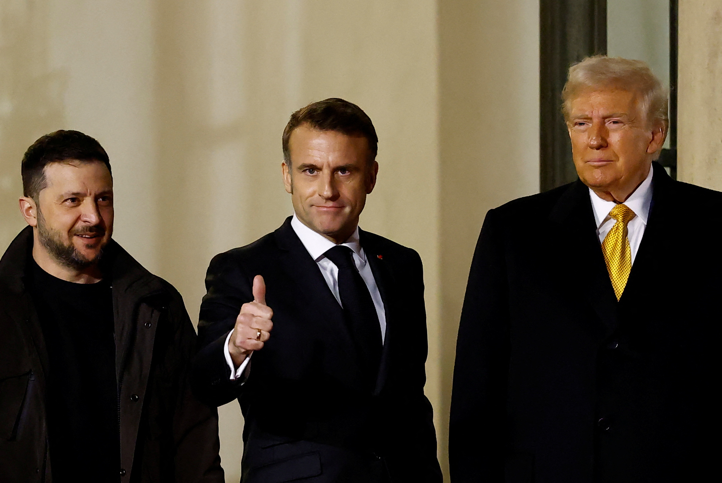 French President Emmanuel Macron accompanies U.S. President-elect Donald Trump and Ukrainian President Volodymyr Zelenskyy at the Elysee Palace in Paris. Christian Hartmann/Reuters