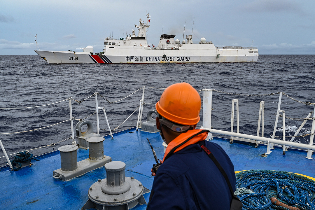 A Chinese Coast Guard ship is seen from a Filipino Coast Guard ship during a supply mission to Sabina Shoal in the South China Sea on August 26, 2024