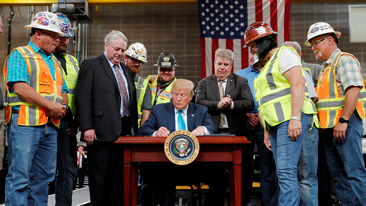 President Donald Trump signs an executive order on energy and infrastructure at the International Union of Operating Engineers International Training and Education Center in Crosby, Texas, in 2019.