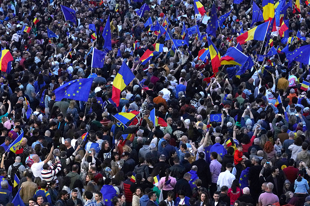 People wave EU and Romanian flags during a pro-EU demonstration in Bucharest, Romania, on March 15, 2025.